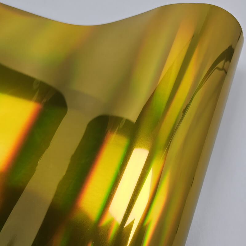 Professional technician installing chrome vinyl wrap with precision tools